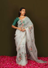 Artistic Organza Silk Off White Saree Featuring Delicate Hand Embroidered Floral Patterns with Dark Green Blouse